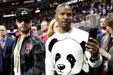 Actor Jamie Foxx, right, watches the teams warm up, before the NFL Super Bowl 53 football game between the Los Angeles Rams and the New England Patriots Sunday, Feb. 3, 2019, in Atlanta. (AP Photo/Mark Humphrey)