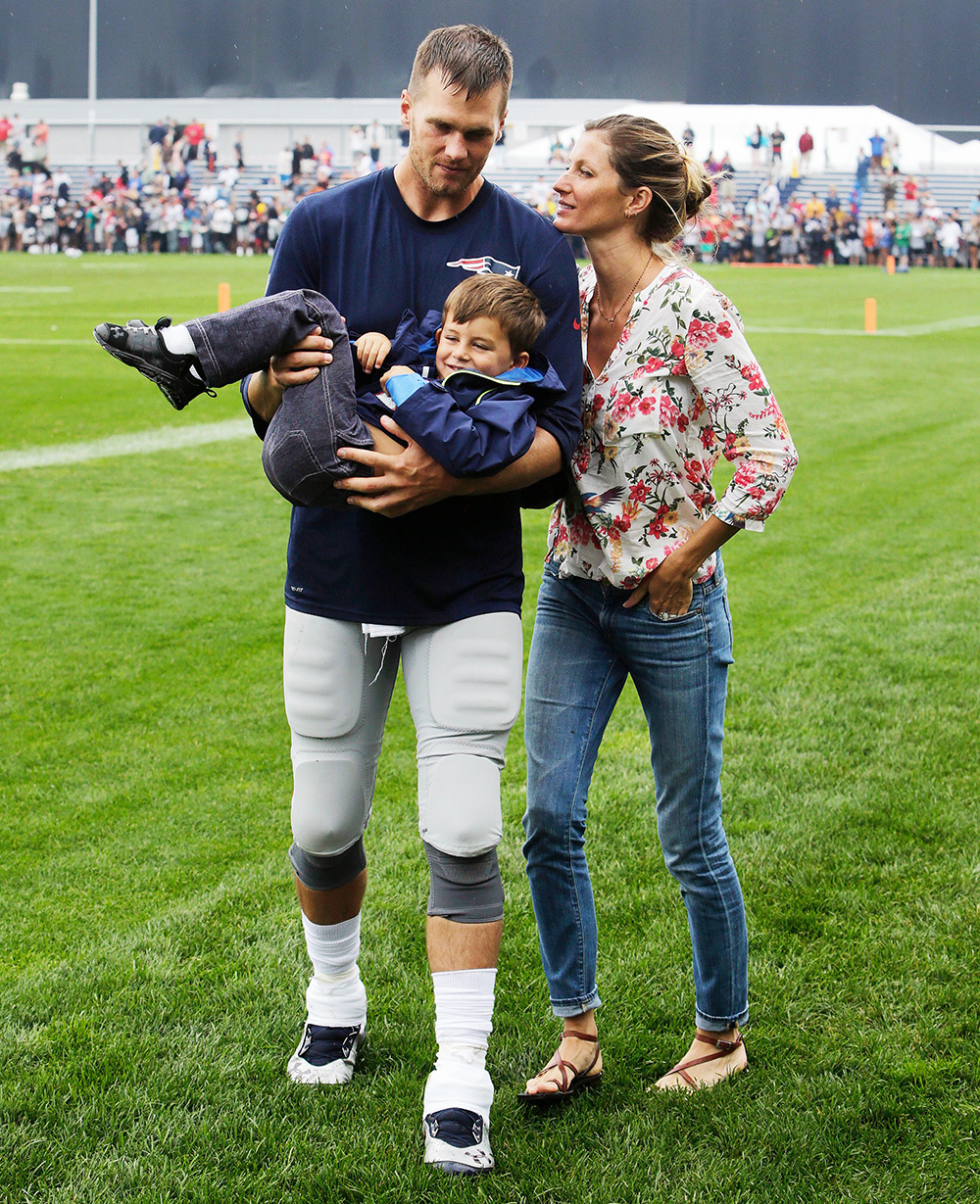 Tom Brady, Gisele Bundchen, Benjamin Brady New England Patriots quarterback Tom Brady carries his son Benjamin with wife Gisele Bundchen at right after joint practice with the Tampa Bay Buccaneers at NFL Football Training Camp, Foxborough, Mass Buccaneers Patriots Camp Football, Foxborough, USA