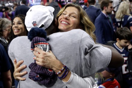 Gisele Bundchen, wife of New England Patriots quarterback Tom Brady, embraces one of the players after the NFL Super Bowl 53 football game against the Los Angeles Rams, Sunday, Feb. 3, 2019, in Atlanta. The Patriots won 13-3. (AP Photo/Patrick Semansky)