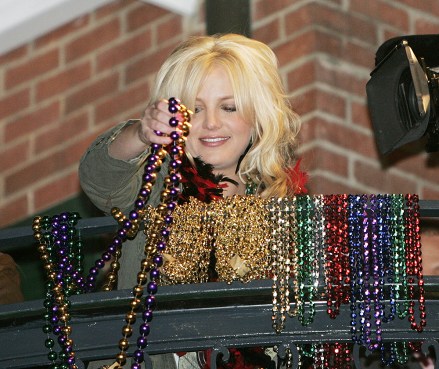 Louisiana native Britney Spears throws some beads from a French Quarter balcony in New Orleans on Monday Feb. 27, 2006. With Mardi Gras only a day away, crowds are flowing into the French Quarter. (AP Photo/Alex Brandon)