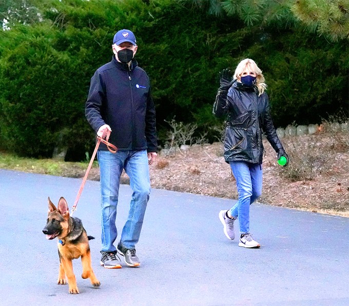 Joe Biden and his wife take their dog for a walk