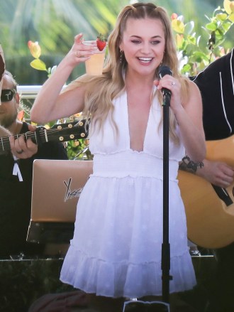 Miami Beach, FL  - American singer-songwriter Kelsea Ballerini was invited to sing for Aerie fans during spring break by The Pool at Strawberry Moon at The Goodtime Hotel in Miami Beach. During the performance, the country singer cools off with a cocktail after finishing her song. The blonde singer sang 3 songs, and on the last one, she confessed that she "just learned" the song.Pictured: Kelsea BalleriniBACKGRID USA 16 MARCH 2022 USA: +1 310 798 9111 / usasales@backgrid.comUK: +44 208 344 2007 / uksales@backgrid.com*UK Clients - Pictures Containing ChildrenPlease Pixelate Face Prior To Publication*