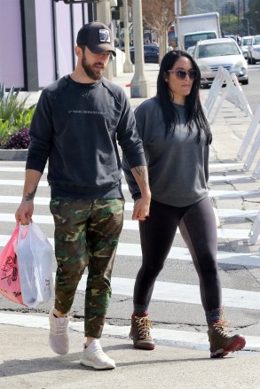 Studio City, CA - *EXCLUSIVE* - Nikki Bella holds onto her fiancé Artem Chigvintsev at the farmers market on Sunday. The two love birds, who are expecting their first child together, wait patiently on a cold Sunday afternoon. Nikki's baby bump can be seen growing as she lifts her sweatshirt to get some air. She munches on some bbq as they leave the market.Pictured: Nikki Bella, Artem ChigvintsevBACKGRID USA 1 MARCH 2020 BYLINE MUST READ: Phamous / BACKGRIDUSA: +1 310 798 9111 / usasales@backgrid.comUK: +44 208 344 2007 / uksales@backgrid.com*UK Clients - Pictures Containing ChildrenPlease Pixelate Face Prior To Publication*