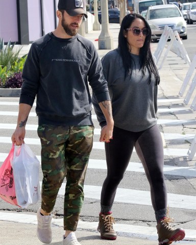 Studio City, CA - *EXCLUSIVE* - Nikki Bella holds onto her fiancé Artem Chigvintsev at the farmers market on Sunday. The two love birds, who are expecting their first child together, wait patiently on a cold Sunday afternoon. Nikki's baby bump can be seen growing as she lifts her sweatshirt to get some air. She munches on some bbq as they leave the market.Pictured: Nikki Bella, Artem ChigvintsevBACKGRID USA 1 MARCH 2020 BYLINE MUST READ: Phamous / BACKGRIDUSA: +1 310 798 9111 / usasales@backgrid.comUK: +44 208 344 2007 / uksales@backgrid.com*UK Clients - Pictures Containing ChildrenPlease Pixelate Face Prior To Publication*