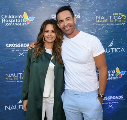 MALIBU, CA - APRIL 29: Brooke Burke (L) and Jorge Cruise attend a benefit dinner for the Nautica Malibu Triathlon and Children's Hospital Los Angeles at the Nautica House on April 29, 2019 in Malibu, California.  (Photo by Noel Vasquez/Getty Images for Nautica/Authentic Brands Group)