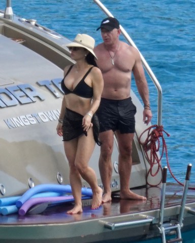 EXCLUSIVE: Amazon boss Jeff Bezos once again shows of his buff body as he cozies up to girlfriend Lauren Sanchez on a boat trip with their family during holiday season in St-Barts. The divorcee, who split from ex-wife MacKenzie Scott in 2019, looked tanned, buff and a far cry from the geeky tech nerd he once was as he cosied up to current squeeze Lauren Sanchez on the Caribbean island. Estimated to be worth £156.8billion ($210billion), Bezos is the second richest man in the world after Elon Musk - and he's undergone a spectacular image transformation since finding his fortune in online shopping. Perhaps the biggest change to Bezos' image in recent years is that he appears to have hit the gym in earnest, substantially beefing up his frame. While the young Bezos was a little rounder of face, by the time he had amassed his fortune he had slimmed down and sported a lean look. However, since meeting new squeeze Lauren Sanchez - but as early as 2017 when he was still with his wife Mackenzie, Bezos has beefed up considerably, sporting the kind of physique usually reserved for action heroes. The 57-year-old puts his newfound beef down to lots of sleep - eight hours a night, a healthy diet and plenty of working out. Even so, Bezos has largely kept his body under wraps until now...but the hot weather in St Barts has clearly left him keen to let loose and showcase the hard work he has put in on making himself more toned. The star oozed confidence on his holiday with lover Sanchez in one of the first sightings of him strutting around in just a pair of shorts. 26 Dec 2021 Pictured: Jeff Bezos and Lauren Sanchez. Photo credit: IMP/Backgrid/EliotPress/MEGA TheMegaAgency.com +1 888 505 6342 (Mega Agency TagID: MEGA816317_001.jpg) [Photo via Mega Agency]