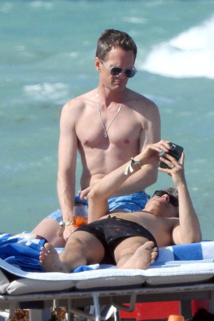 Neil Patrick Harris and David Burtka on a beach