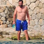 *EXCLUSIVE*  Adam Sandler takes a break from his filming duties to relax out on the beach in Palma De Mallorca