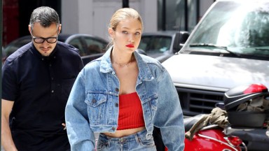 Gigi Hadid sports a pink and blue hoodie with a denim vest and