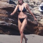 *EXCLUSIVE* 'Boogie Nights' actress Heather Graham slips into a black bikini for a beachside frolic next to mystery man
