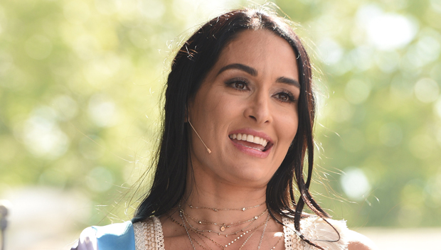 Nikki Bella flaunts her cleavage and midriff in cropped lace top and yellow  pants at charity event