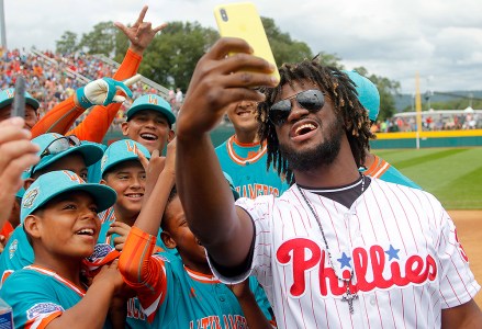 Philadelphia Phillies outfielder Odubel Herrera takes a selfie with members of the Panama Little League team before their game against Japan in an International pool play baseball game at the Little League World Series tournament in South Williamsport, Pa
LLWS Panama Japan1 Baseball, South Williamsport, USA - 19 Aug 2018