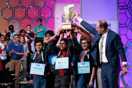 E.W. Scripps CEO Adam Symson, right, presents a trophy to the eight co-champions of the Scripps National Spelling Bee, in Oxon Hill, Md. The spelling bee ended in unprecedented 8-way championship tie after organizers ran out of challenging wordsSpelling Bee, Oxon Hill, USA - 31 May 2019