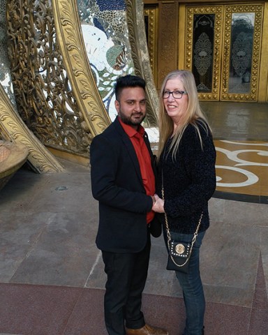 Jenny and Sumits hero shot in a temple in India.