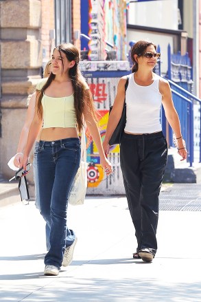 NEW YORK, NY - *EXCLUSIVE* Katie Holmes and her daughter Suri Cruise wear matching outfits for a fun stroll through New York City. PHOTOS: Katie Holmes, Suri Cruise BACKGRID USA 27 July 2021 BYLINE MUST READ: Ulices Ramales / BACKGRID USA: +1 310 798 9111 / usasales@backgrid.com UK: +44 208 344 2007 / uksales@backgrid.com * UK Client - Photos with children should have their faces pixelated before publishing*