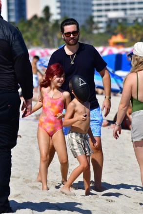 Miami, FL - Scott Disick is a happy father as we see the star spend time with his 3 children Penelope, Mason and Reign in Miami.  Scott frolicks in the water with his daughter Penelope and youngest son Reign (who wears a Squid Games mask) while Mason relaxes on a beach chair.  Image: Scott Disick, Penelope Disick, Reign Disick BACKGRID USA 22 FEBRUARY 2022 USA: +1 310 798 9111 / usasales@backgrid.com UK: +44 208 344 2007 / uksales@backgrid.com * UK Containing Pictures Children.  Face before publication *