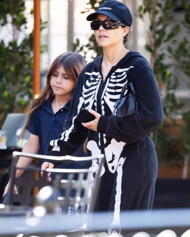Calabasas, CA  - *EXCLUSIVE*  - Kourtney Kardashian looked like 'death' wearing a skeleton jumper as she stepped out makeup-free with her daughter Penelope Disick for a healthy smoothie from Sunlife Organics in Calabasas.  Pictured: Kourtney Kardashian, Penelope Disick  BACKGRID USA 16 MAY 2022   BYLINE MUST READ: IXOLA / BACKGRID  USA: +1 310 798 9111 / usasales@backgrid.com  UK: +44 208 344 2007 / uksales@backgrid.com  *UK Clients - Pictures Containing Children Please Pixelate Face Prior To Publication*
