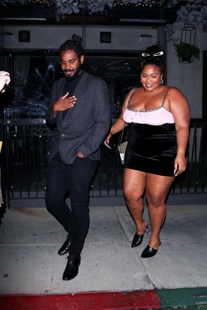 Beverly Hills, CA  - *EXCLUSIVE*  - Singer Lizzo looks smitten on a  night out with a handsome mystery man at Crustacean in Beverly Hills. The Good as Hell singer was all smiles as she exited the restaurant on Wednesday night with her tall companion walking ahead of her to make sure he led the way and was able to open the car door for her as they left together. The Juice singer has kept her dating life very quiet and though she's been rumored to have been dating after she was pictured on a yacht in Malibu with an unidentified guy and even linked to Chris Evans after messaging him, she has not revealed who or if she was dating anyone. In a 2020 interview with Vogue she said that her song ‘Truth Hurts’ is based on a real person saying “damn near a profile on a human being minus his name.”Pictured: LizzoBACKGRID USA 14 OCTOBER 2021 BYLINE MUST READ: BACKGRIDUSA: +1 310 798 9111 / usasales@backgrid.comUK: +44 208 344 2007 / uksales@backgrid.com*UK Clients - Pictures Containing ChildrenPlease Pixelate Face Prior To Publication*