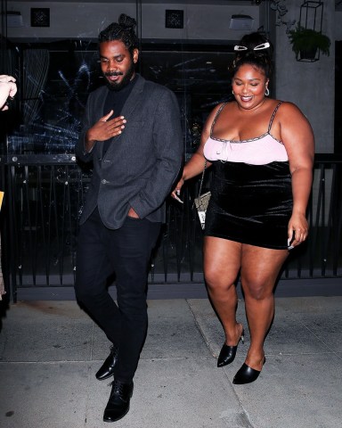 Beverly Hills, CA  - *EXCLUSIVE*  - Singer Lizzo looks smitten on a  night out with a handsome mystery man at Crustacean in Beverly Hills. The Good as Hell singer was all smiles as she exited the restaurant on Wednesday night with her tall companion walking ahead of her to make sure he led the way and was able to open the car door for her as they left together. The Juice singer has kept her dating life very quiet and though she's been rumored to have been dating after she was pictured on a yacht in Malibu with an unidentified guy and even linked to Chris Evans after messaging him, she has not revealed who or if she was dating anyone. In a 2020 interview with Vogue she said that her song ‘Truth Hurts’ is based on a real person saying “damn near a profile on a human being minus his name.”  Pictured: Lizzo  BACKGRID USA 14 OCTOBER 2021   BYLINE MUST READ: BACKGRID  USA: +1 310 798 9111 / usasales@backgrid.com  UK: +44 208 344 2007 / uksales@backgrid.com  *UK Clients - Pictures Containing Children Please Pixelate Face Prior To Publication*