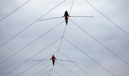Nik Wallenda and his sister Lijana Wallenda perform on a tightrope before the NASCAR Sprint Cup Series auto race at Charlotte Motor Speedway in Concord, N.C., Saturday, Oct. 12, 2013. (AP Photo/Terry Renna)
