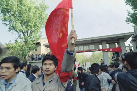 A Beijing University student marcher holds a red flag aloft as he emerges from campus, . Students from several Beijing universities participated in a planned march to Tiananmen Square in Beijing in defiance of a government demand they end their campaign for political reform
China Pro Democracy Protests, Beijing, China