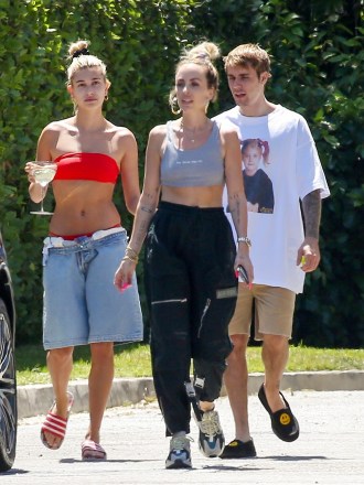 Beverly Hills, CA  - *EXCLUSIVE*  - Justin Bieber and Hailey Baldwin Bieber are enjoying the warm Cali sun in Beverly Hills. Hailey, who wears a red bikini underneath her oversized jean shorts, sips on a drink while walking next to her hubby JB. The couple enjoyed a day out together amidst ongoing war with Taylor Swift and Bieber's manager Scooter Braun.Pictured: Justin Bieber, Hailey BieberBACKGRID USA 2 JULY 2019 USA: +1 310 798 9111 / usasales@backgrid.comUK: +44 208 344 2007 / uksales@backgrid.com*UK Clients - Pictures Containing ChildrenPlease Pixelate Face Prior To Publication*