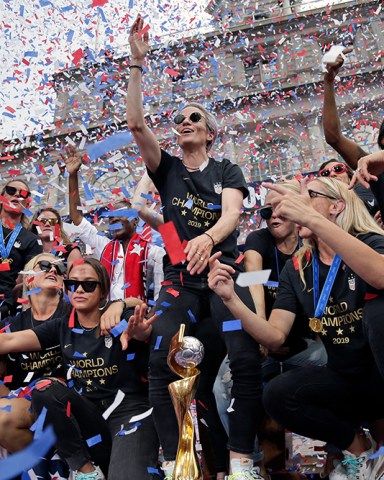 The U.S. women's soccer team, Megan Rapinoe center, celebrates at City Hall after a ticker tape parade, in New York. The U.S. national team beat the Netherlands 2-0 to capture a record fourth Women's World Cup title
WWCup US Returns Home Soccer, New York, USA - 10 Jul 2019