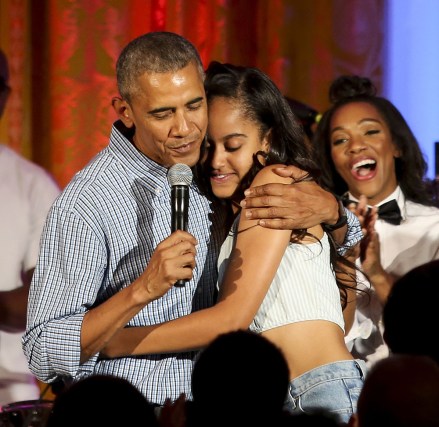 US President Barack Obama hugs his daughter Malia, after singing to her Happy Birthday, at the Fourth of July White House party, while singer Janelle Monae (R) reacts
White House Independence Day party, Washington, D.C, America - 04 Jul 2016
Guests at the party included military families and staff and their families from throughout the administration. Because of the rain the party was moved from the South Lawn to the East Room of the White House.