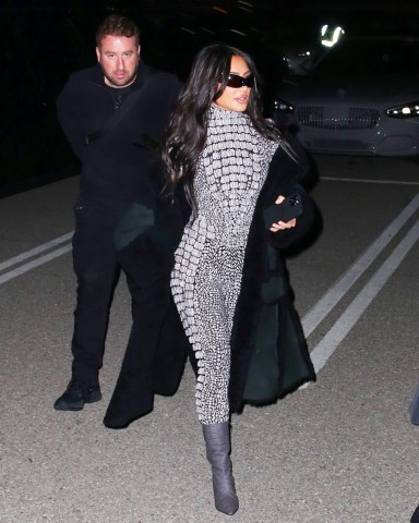 Inglewood, CA  - *EXCLUSIVE*  - Reality star Kim Kardashian is hard to miss in a shimmering catsuit while attending singer SZA’s show at the The Kia Forum in Inglewood with her assistant. Recently Kim posted a photo of Sza in the new ad campaign for her line of body shapers. The award-winning songstress appears in the latest campaign for Skims wearing pieces from the brand's Fits Everybody collection. 

Kim was seen wearing a grey catsuit, long coat, grey boots and sunglasses as she arrived to the venue on Wednesday night

Pictured: Kim Kardashian

BACKGRID USA 23 MARCH 2023 

BYLINE MUST READ: ALEXJR / BACKGRID

USA: +1 310 798 9111 / usasales@backgrid.com

UK: +44 208 344 2007 / uksales@backgrid.com

*UK Clients - Pictures Containing Children
Please Pixelate Face Prior To Publication*