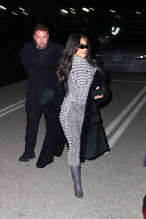 Inglewood, CA  - *EXCLUSIVE*  - Reality star Kim Kardashian is hard to miss in a shimmering catsuit while attending singer SZA’s show at the The Kia Forum in Inglewood with her assistant. Recently Kim posted a photo of Sza in the new ad campaign for her line of body shapers. The award-winning songstress appears in the latest campaign for Skims wearing pieces from the brand's Fits Everybody collection. Kim was seen wearing a grey catsuit, long coat, grey boots and sunglasses as she arrived to the venue on Wednesday nightPictured: Kim KardashianBACKGRID USA 23 MARCH 2023 BYLINE MUST READ: ALEXJR / BACKGRIDUSA: +1 310 798 9111 / usasales@backgrid.comUK: +44 208 344 2007 / uksales@backgrid.com*UK Clients - Pictures Containing ChildrenPlease Pixelate Face Prior To Publication*