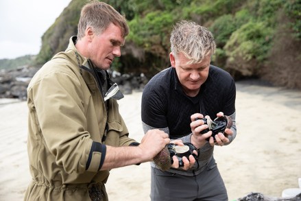 New Zealand - Zane (L), a local fisherman, teaches Gordon Ramsay how to open pāua, one of the ocean's greatest delicacies. (National Geographic/Camilla Rutherford)