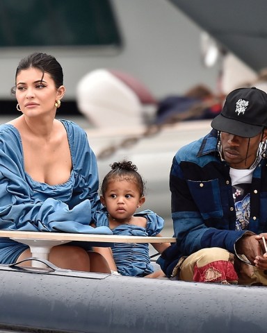 ** RIGHTS: ONLY UNITED STATES, BRAZIL, CANADA ** Portofino, ITALY  - *EXCLUSIVE*  - Kylie Jenner enjoys the day with her adorable daughter Stormy wearing matching denim ruffled dresses by TLZ L'FEMME in Portofino with family. Birthday girl Kylie and Stormy take in the sights with daddy Travis Scott, Scott Disick, Sofia Richie and her mother Kris Jenner and Corey Gamble. The gang arrive at shore via a dinghy ride and strolled through the coastal town of Portofino and turned a few heads with a variety of striking outfits as they go shopping all looking rather glammed up on their Italian break. *Shot on 08/12/19*  Pictured: Kylie Jenner - Travis Scott  BACKGRID USA 13 AUGUST 2019   BYLINE MUST READ: Cobra Team / BACKGRID  USA: +1 310 798 9111 / usasales@backgrid.com  UK: +44 208 344 2007 / uksales@backgrid.com  *UK Clients - Pictures Containing Children Please Pixelate Face Prior To Publication*