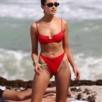 Olivia Culpo stands out in a red bikini as she hits the beach with model Devon Windsor in Miami
