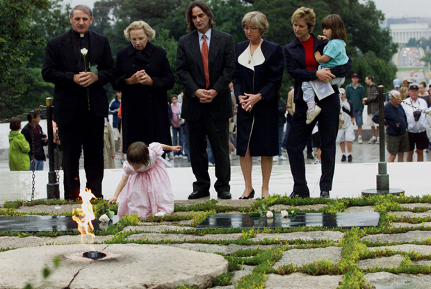 CAPTION CORRECTION Robert F. Kennedy's granddaughter Saoirse Kennedy Hill places a white rose at the Eternal Flame, President John F. Kennedy's gravesite, at Arlington National Cemetery in Arlington, Va., . Earlier the group took part in a ceremony honoring the 38th anniversary of Robert F. Kennedy's death. Kennedy was shot in Los Angeles on June 5, 1968. From left are, Father Gerry Creedon; Ethel Kennedy, RFK's widow; Paul Hill; Courtney Kennedy Hill; and Kerry Kennedy Cuomo, holding daughter MichaelaRFK, WASHINGTON, USA