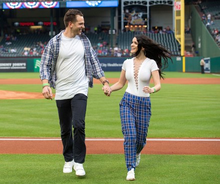 Adam Gottschalk, a contestant on ABC's "The Bachelorette", left, and Raven Gates, a contestant on "The Bachelor" walk off the field after Gottschalk threw out a ceremonial first pitch before a baseball game between the Texas Rangers and the Toronto Blue Jays, in Arlington, Texas. Toronto won 8-5
Blue Jays Rangers Baseball, Arlington, USA - 06 Apr 2018