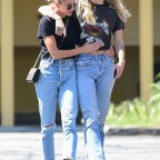 Miley Cyrus and Kaitlynn Carter can't keep their hands off each other while out for a walk in LA!