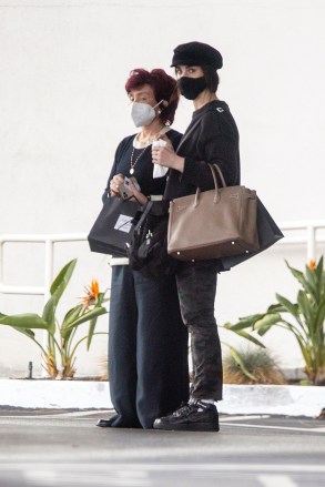 Beverly Hills, CA  - *EXCLUSIVE*  - Sharon Osbourne and her daughter Aimee wait for their car at the valet after shopping together at Saks Fifth Avenue in Beverly Hills. Aimee, who has over the years chosen to remain out of the spotlight released her debut album last fall titled,  Vacare Adamare, Latin for "to be free and loved.''. The 37 year old stepped out with her mom for a shopping trip in camouflage pants, sneakers, a black jersey top and newsboy cap.Pictured: Sharon Osbourne, Aimee OsbourneBACKGRID USA 24 JANUARY 2021 USA: +1 310 798 9111 / usasales@backgrid.comUK: +44 208 344 2007 / uksales@backgrid.com*UK Clients - Pictures Containing ChildrenPlease Pixelate Face Prior To Publication*