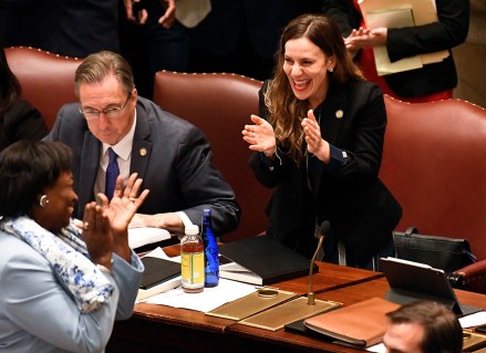 New York Sen. Alessandra Biaggi, D-Bronx, right, celebrates after her legislation passed to change state legal standards on sexual harassment to help victims prove harassment cases as members discuss the Bill in the Senate Chamber at the state Capitol, in Albany, N.Y
New York Legislature, Albany, USA - 19 Jun 2019