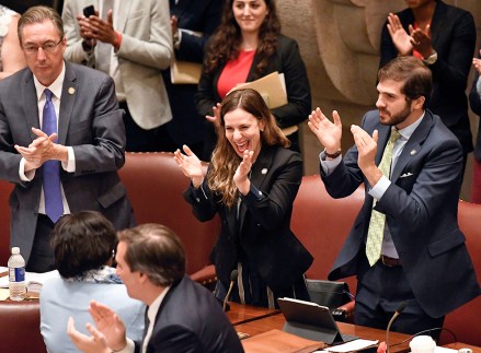 New York Sen. Alessandra Biaggi, D-Bronx, center, celebrates after her legislation to change state legal standards on sexual harassment to help victims prove harassment cases, as members discuss the bill in the Senate Chamber at the state Capitol, in Albany, N.Y
New York Legislature, Albany, USA - 19 Jun 2019