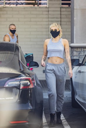 Calabasas, CA - *EXCLUSIVE* - Miley Cyrus was seen picking up supplies from CVS Pharmacy in Calabasas wearing no bra, and exposing her mid-riff while loading groceries with her man, Cody Simpson, and her new mullet hair-do.Pictured: Mmiley Cyrus, Cody SimpsonBACKGRID USA 12 JUNE 2020 BYLINE MUST READ: IXOLA / BACKGRIDUSA: +1 310 798 9111 / usasales@backgrid.comUK: +44 208 344 2007 / uksales@backgrid.com*UK Clients - Pictures Containing ChildrenPlease Pixelate Face Prior To Publication*