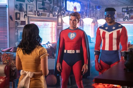 Riverdale -- "Chapter Sixty-One: Halloween" -- Image Number: RVD404b_0249.jpg -- Pictured (L-R): Camila Mendes as Veronica, KJ Apa as Archie and Eli Goree as Munroe -- Photo: Jack Rowand/The CW -- © 2019 The CW Network, LLC. All Rights Reserved.