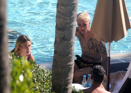 EXCLUSIVE: Justin Bieber and wife Hailey Bieber relax by the pool on Thanksgiving Day in Miami. 28 Nov 2019 Pictured: Justin Bieber; Hailey Bieber. Photo credit: MEGA TheMegaAgency.com +1 888 505 6342 (Mega Agency TagID: MEGA558066_001.jpg) [Photo via Mega Agency]