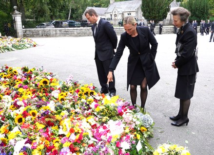 Britain's Princess Anne, right and her children, Peter Phillips, left and Zara Tindall view flowers left by members of the public following the death of Queen Elizabeth II, outside the gates of Balmoral Castle in Aberdeenshire, Scotland . Queen Elizabeth II, Britain's longest-reigning monarch and a rock of stability across much of a turbulent century, died Thursday after 70 years on the throne. She was 96
Royals, Balmoral, United Kingdom - 10 Sep 2022