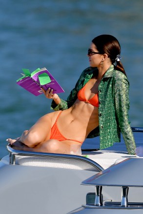 Kendall Jenner wears an orange bikini during a boat ride in Miami Beach,Florida.Kendall had lunch and later read a book.Pictured: Kendall JennerRef: SPL5134058 061219 NON-EXCLUSIVEPicture by: Robert O'Neil / SplashNews.comSplash News and PicturesLos Angeles: 310-821-2666New York: 212-619-2666London: +44 (0)20 7644 7656Berlin: +49 175 3764 166photodesk@splashnews.comWorld Rights
