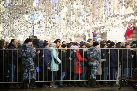 People stand under Christmas decorations as they wait in a long queue to enter Red Square to celebrate New Year in Moscow, Russia, . The crowds are controlled as they enter Red Square for the traditional New Year celebrations watched mainly by tourists
Russia New Year, Moscow, Russian Federation - 31 Dec 2019