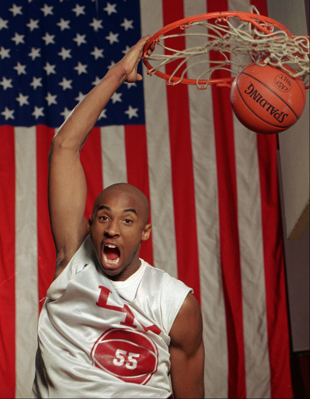 KOBE BRYANT With a large flag as a backdrop, Kobe Bryant dunks the ball at his Lower Merion, Pa. high school gym during a practice . The 6-foot 6 suburban Philadelphia phenom can play for any college in the nation or he may jump right from high school to pro basketball
KOBE'S QUANDARY, LOWER MERION, USA