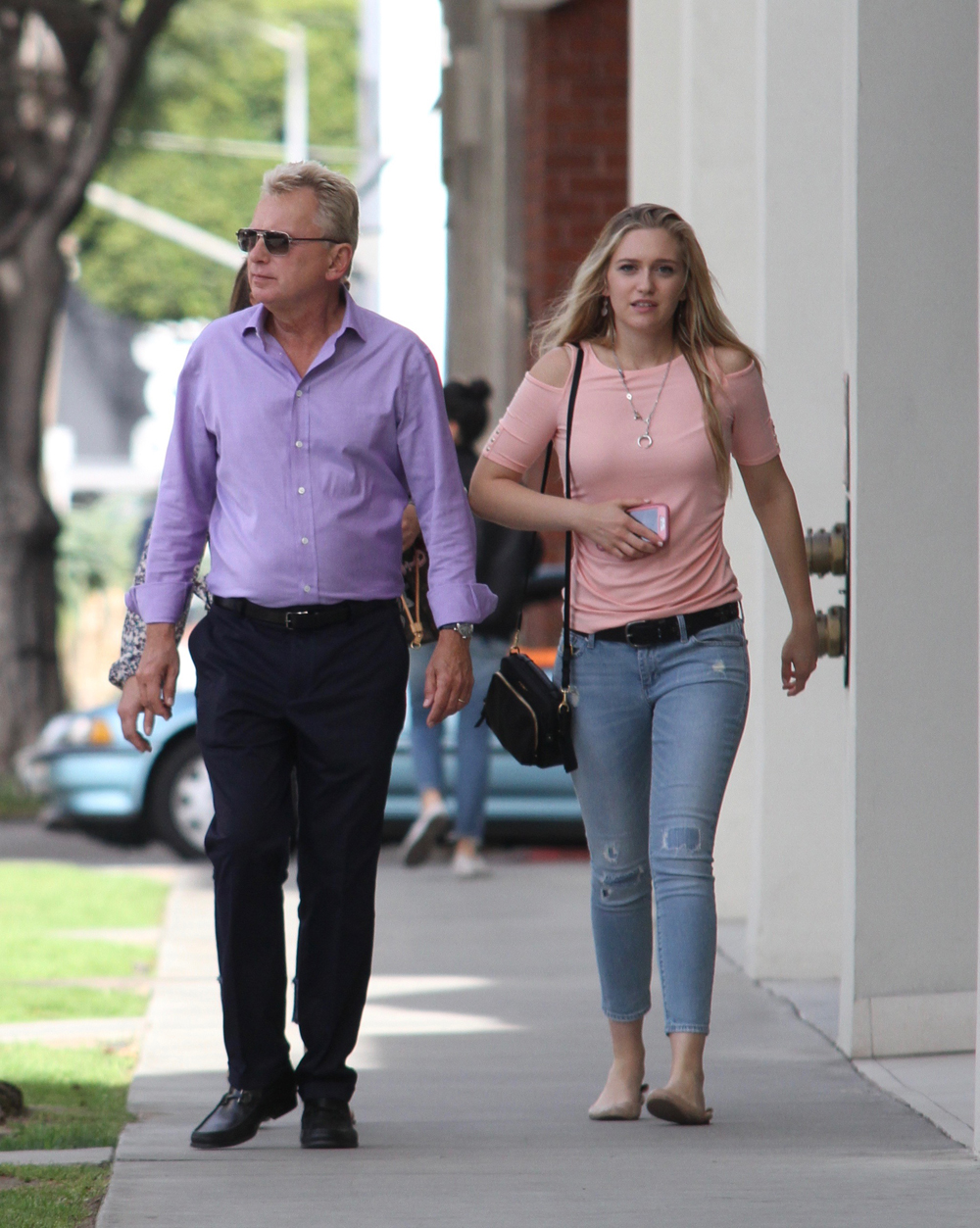 EXCLUSIVE: Former Wheel of Fortune host Pat Sajak feeds a parking meter to shop with wife Lesley and daughter Maggie