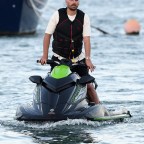 EXCLUSIVE: Scott Disick shows off his new pink hair as he takes a ride on a jet ski while girlfriend Amelia Hamlin waits on the dock with a friend in Miami