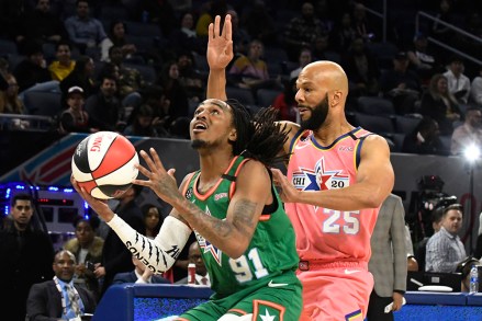 Team Stephen A's Quavo, left, is defended by Team Wilbon's Common, right, during the first half of an NBA Celebrity All-Star basketball game Friday, Feb. 14, 2020, in Chicago. (AP Photo/David Banks)