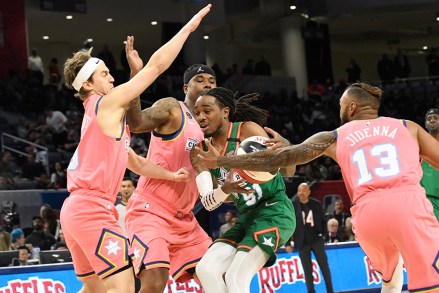 Team Stephen A's Quavo, center, is defended by Team Wilbon's Jidenna, right, and Alex Moffat, left, during the first half of the NBA Celebrity All-Star basketball game Friday, Feb. 14, 2020, in Chicago. (AP Photo/David Banks)